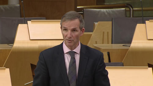 An image of Liam McArthur asking a question in the Scottish Parliament chamber